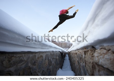 girl jump high over snow mountain in winter season