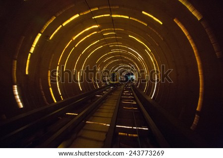 Yellow train tunnel with lighting