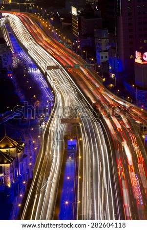 shanghai city traffic in night with car lamp track