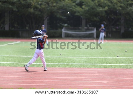 One boy practice the baseball at school yard