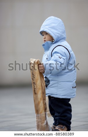 chinese baby boy taking the bread package home