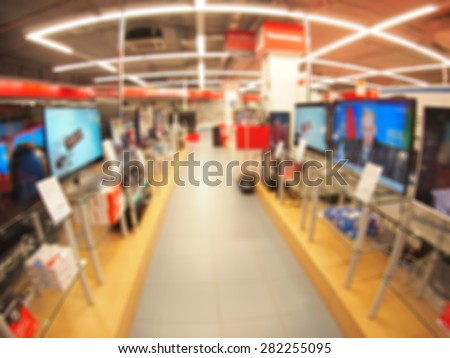 Defocused and blur image of a shop selling household appliances and TVs with wide angle distortion view was blurred for use as a background