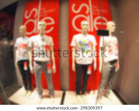 Defocused and blurry four male mannequin in a shopping center in T-shirts and trousers with wide angle distortion view was blurred for use as a background