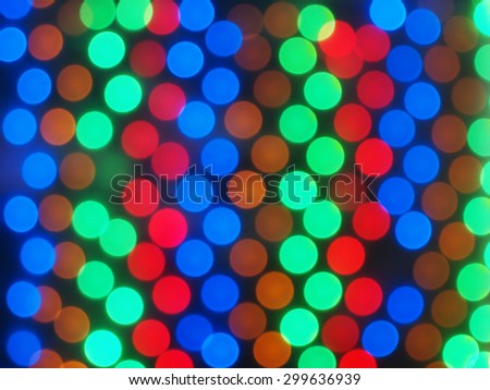 Defocused and blurry image of multicolored lights on a dark background in the form of circles in the correct order was blurred for use as a background
