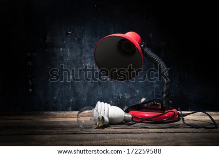 Vintage background with lighting retro red lamp on wood table