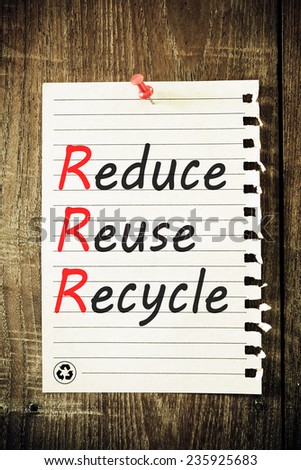 reduce, reuse and recycle reminder note against grained wood - resource conservation concept