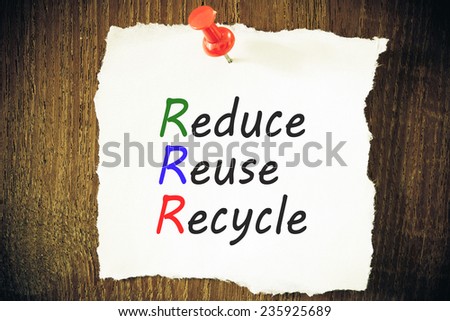 reduce, reuse and recycle reminder note against grained wood - resource conservation concept