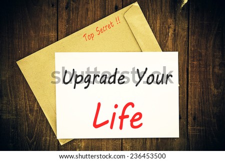 The phrase Upgrade Your Life typed on a piece of paper