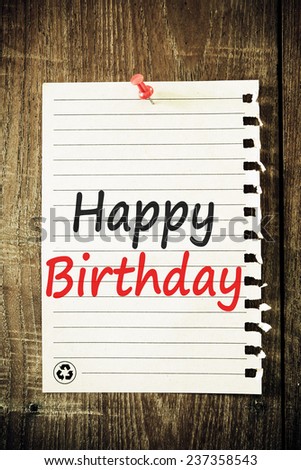 text happy birthday on the short note vintage paper with tape on wood background