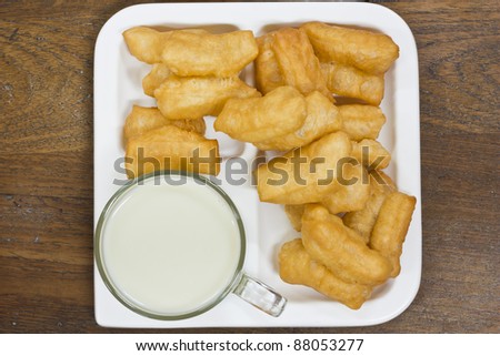 Deep fried dough sticks and a cup of soybean milk on tray