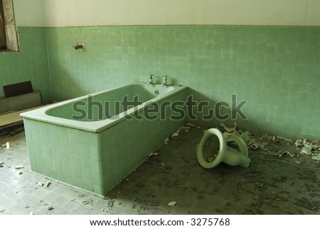 broken bathtub and toilet bowl in an Abandoned House