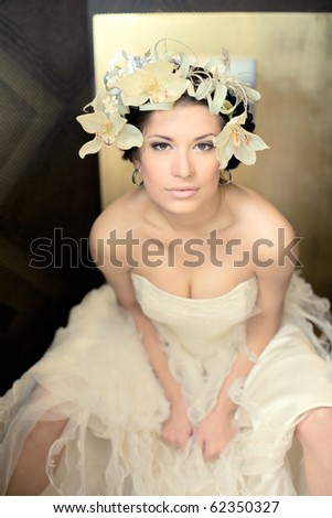 Beautiful bride  brunette with flowers in hairs  in a sexual pose