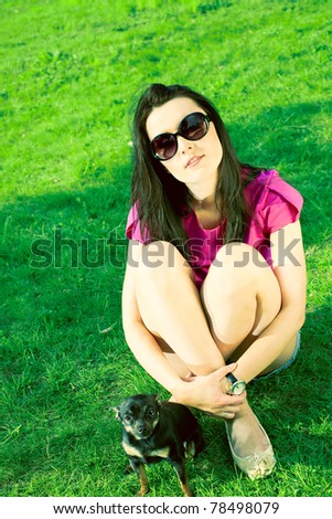 Girl with glasses and a puppy in the garden
