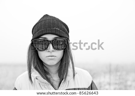 beautiful young woman in  hat and sunglasses in winter