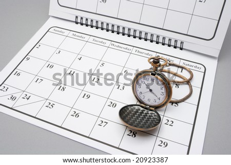 Pocket Watch on Calendar with Grey Background