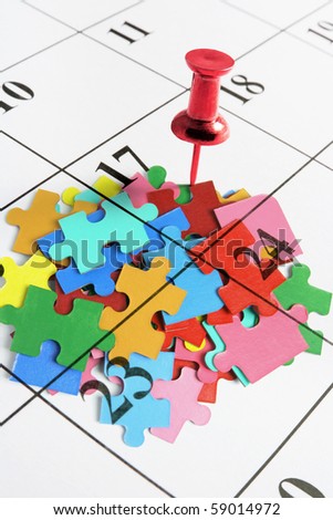 Thumb Tack on Calendar with Puzzles on Calendar Page