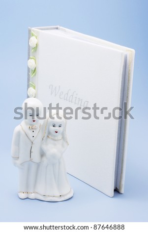 stock photo Wedding Couple Figurine on Blue Background