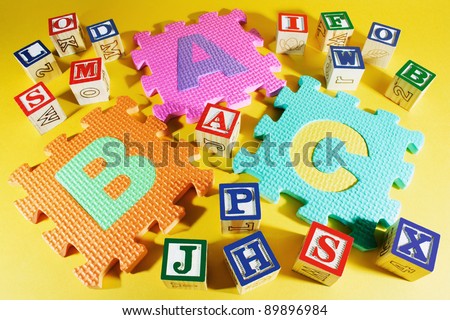 Alphabet Blocks and Alphabet Puzzles on Yellow Background