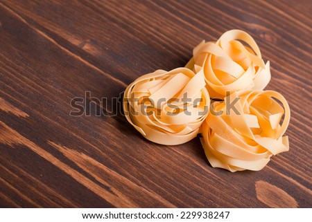 pasta raw three circles on a brown wooden table