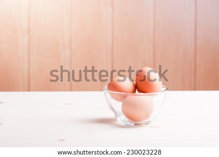 brown egg on a light wooden table side view