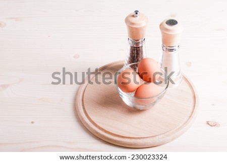 brown eggs on bright spices wooden table side view