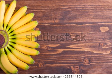 yellow bananas baby tips up the left fan on brown board to the right place for your text