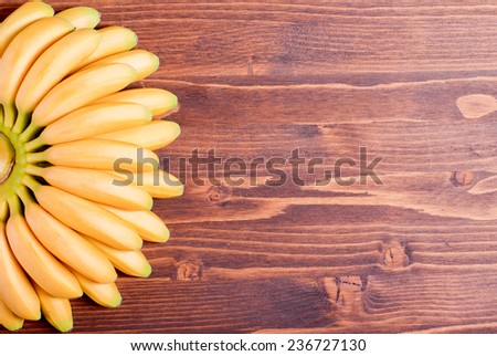 yellow bananas baby tips down the left fan on brown board to the right place for your text