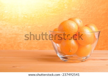 Beautiful ripe oranges on the table and a yellow orange background