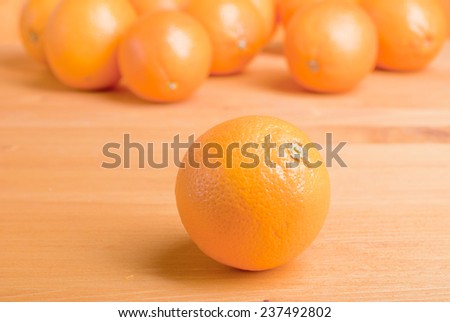 Beautiful ripe oranges on the table and a yellow orange background
