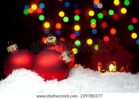 Christmas toys in the snow with a Christmas tree with garlands of bokeh