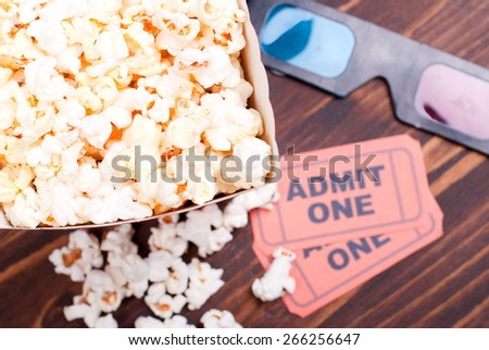 popcorn on  table movie tickets, 3D glasses top view