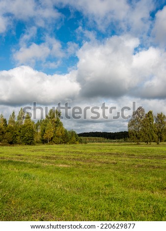 Country landscape under morning sky with clouds. Overcast sky before storm.