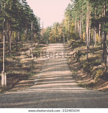 country gravel road in the forest. latvia.. Vintage photography effect.