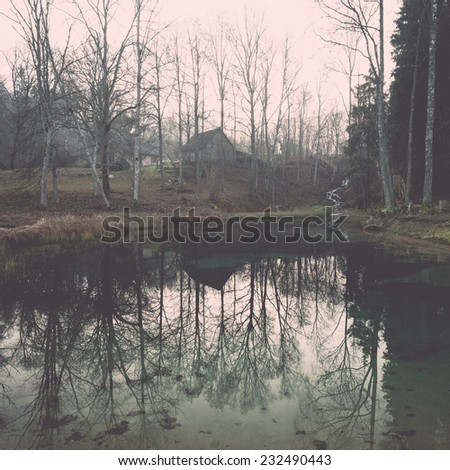 clear morning by small lake with reflections in latvia. Vintage photography effect.