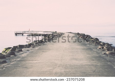 breakwater in the sea with lighthouse on it near Riga, latvia - retro, vintage style look