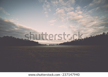 Majestic country landscape under morning sky with clouds. - retro, vintage style look