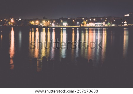 city light reflections over water at the night - retro, vintage style look
