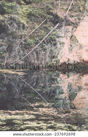 old river bank with reflections in water. Latvia. - retro, vintage style look