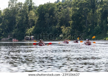 tourists enjoying water sports, kayaking in wild river - Sigulda, Latvia, 2014-07-27
