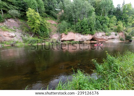 tourists enjoying water sports, kayaking in wild river - Sigulda, Latvia