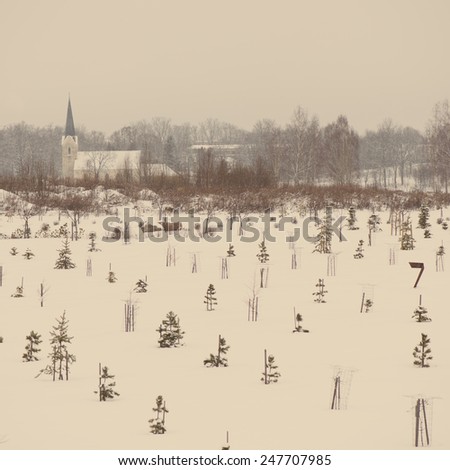 country chruch in winter with snow covered trees in country - aged photo effect, vintage retro