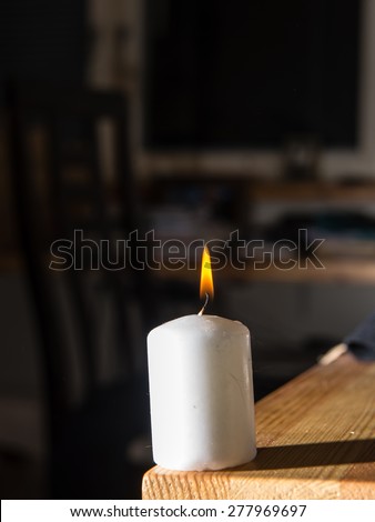 Smoke coming from a blown out candle with dark background