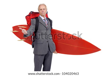 Mature businessman hitchhiking with backpack and surf board