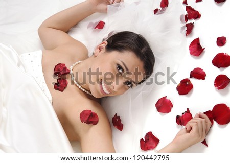 Beautiful bride posing with rose petals