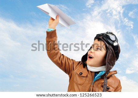 Young boy pilot with a paper plane