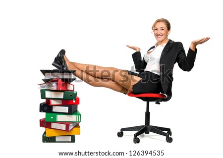 Sexy business woman seated in a chair with feet over a stack of files isolated in white