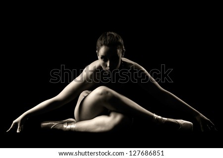 Ballerina posing in a dark background