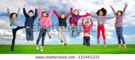 Group of children jumping outdoors Group of children jumping outdoors