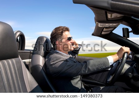 Businessman in his car with cellphone