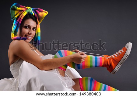 Beautiful funny bride posing with colorful socks and shoes